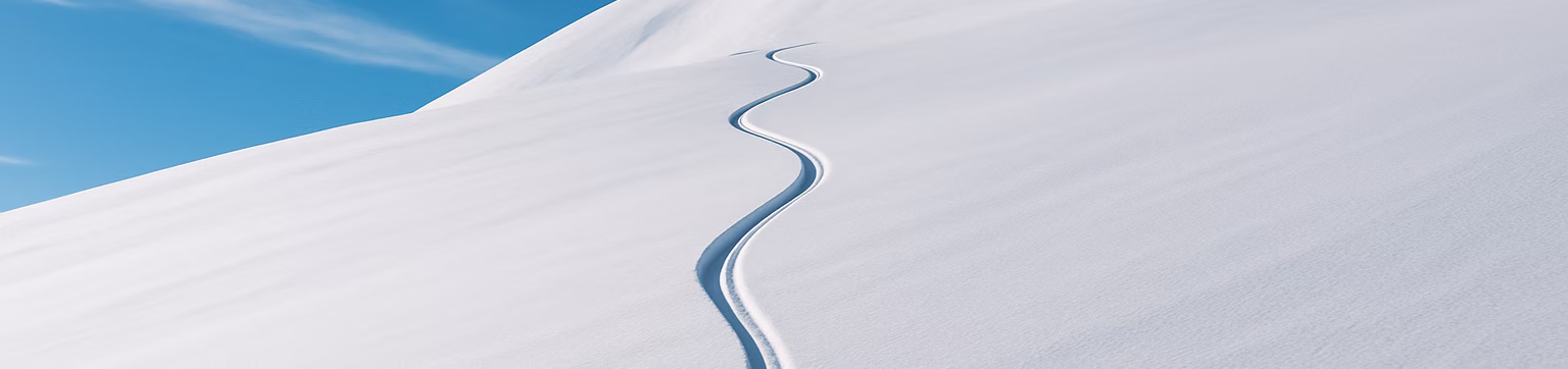 A clean line carved through a snowy mountainside